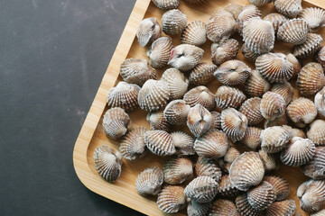 top view of cockles on a plate on black background 