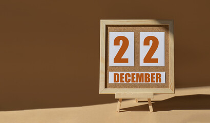 December 22th. Day 22 of month, Calendar date. Cork board, easel in sunlight on desktop. Close-up,...