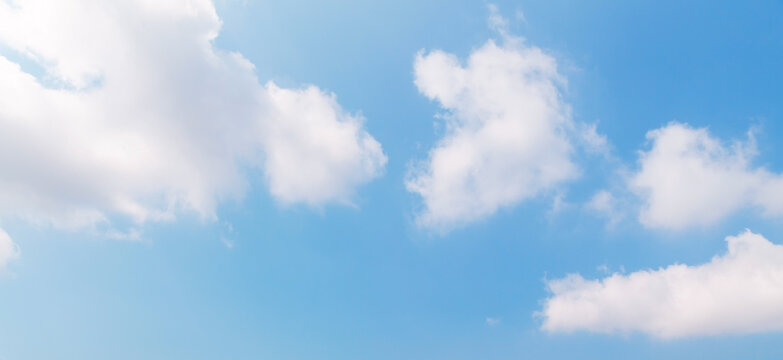 Blue sky with white cumulus clouds on a sunny day