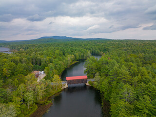 Hancock Greenfield Covered Bridge aerial view on Cantoocook River between town of Hancock and Greenfield in New Hampshire NH, USA.  - obrazy, fototapety, plakaty