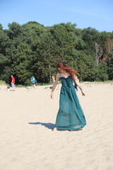 beautiful girl in a dress on the beach