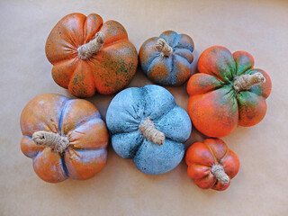 Artificial alabaster pumpkins lie on the background of the craft