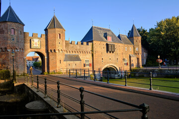 Amersfoort, The Netherlands, August 8, 2022. The Koppelpoort medieval gate and city walls against a clear blue sky.