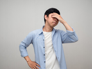 Worker man blue shirt hold his head feels dizzy isolated