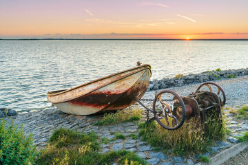 Fishing boat on the dutch dike at sunset