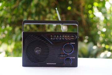 Closeup vintage old transistor radio, placed outdoor in evening light. Concept : Analog technology...