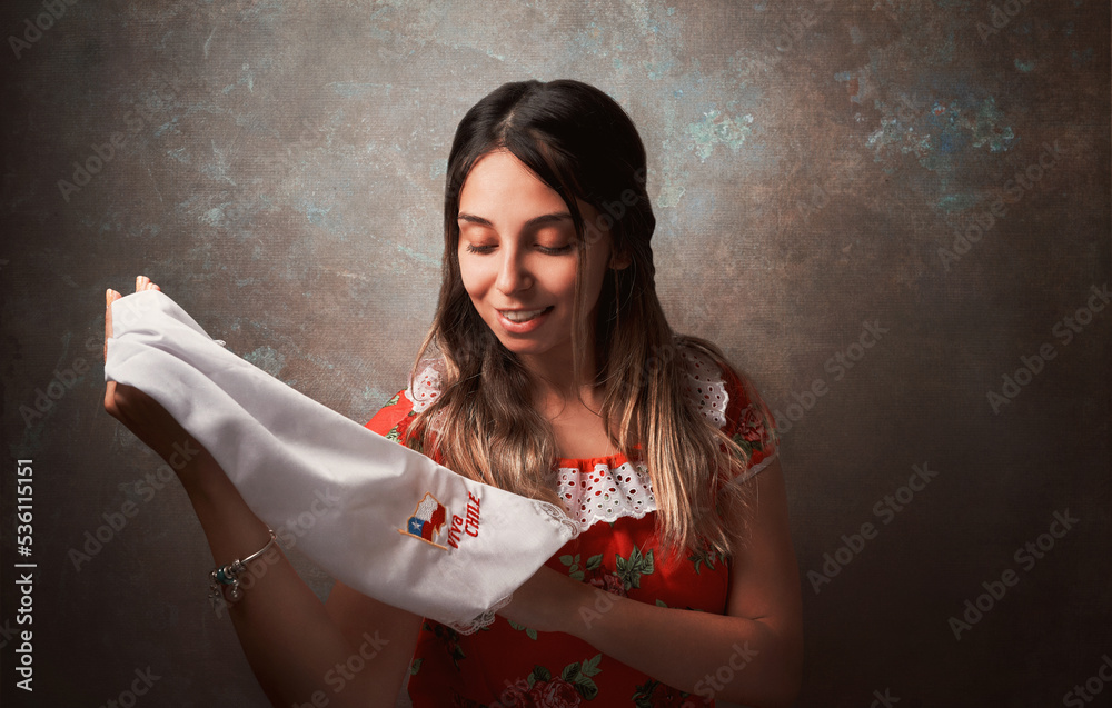 Wall mural young chilean woman portrait with national costume or dress holding a scarf with chilean flag