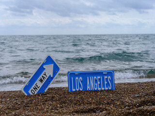 one way and  Los Angeles sign on the beach.