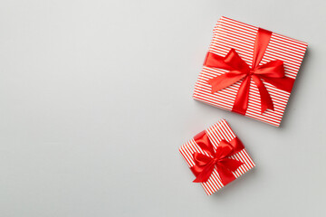 Fototapeta na wymiar Christmas gift boxes on color background, top view