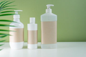 
template of cosmetic jars shampoo and dispenser, with a place for design on a green background. packaging for cosmetics on a beautiful background.