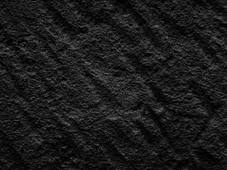 Black cut stone texture background. Dark cut stone with chisel marks surface.