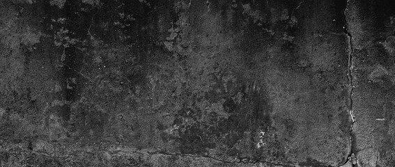 Dirty black concrete wall texture background. Wide panoramic view of empty dark concrete wall