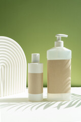 
template of cosmetic jars shampoo and dispenser, with a place for design on a green background. packaging for cosmetics on a beautiful background.