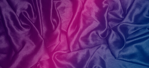 Gradient of colours on silk luxury fabric making a background wallpaper