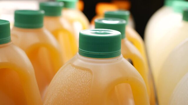 plastic bottle of orange juice in a shelf 