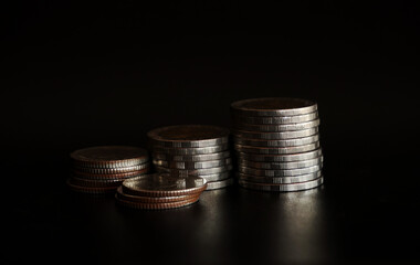 Stack of coins on black background, Saving money concept