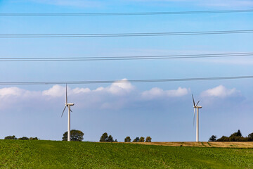 Maribo, Denmark  Power lines and wind turbines in a field.