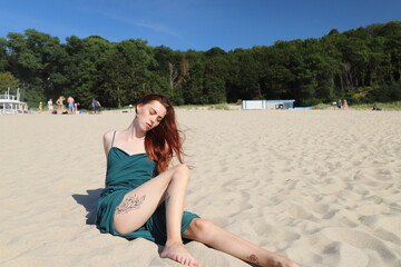 beautiful girl in a dress on the beach