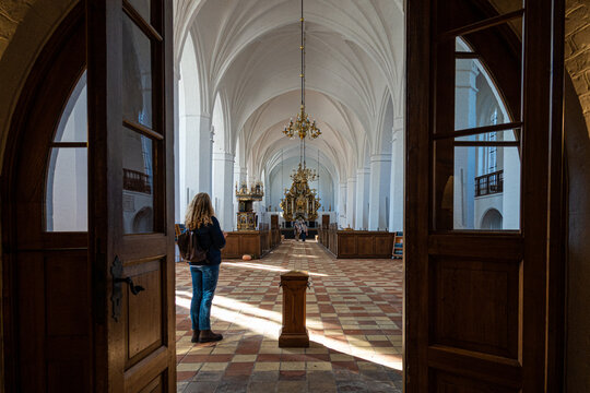 Maribo, Denmark A woman stands at the entrance to the  Maribo Cathedral.