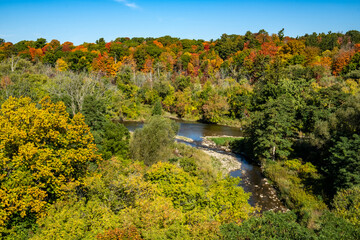 Fototapeta na wymiar Beautiful View of the Credit River Valley From Above with Colorful Fall Foliage Against the blue Sky