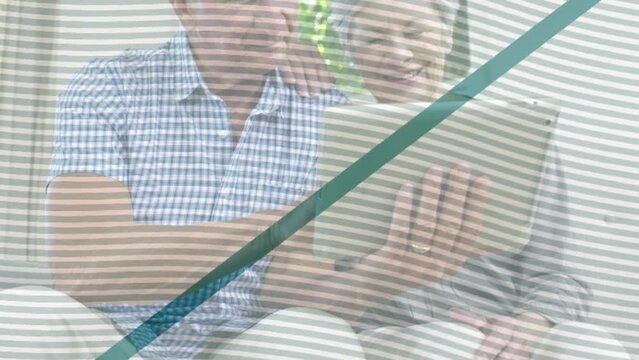 Animation of shapes over senior caucasian couple using tablet
