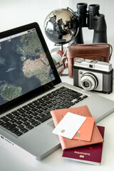 Book a trip, with a blank credit card, decorated with a vintage camera and binoculars. travel concept