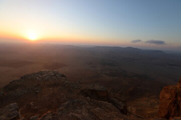 Sunrise on the shore of the Dead Sea in Israel. The sun rises from behind the mountains in Jordan.