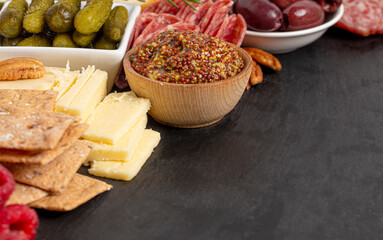 Meat and Cheese Charcuterie Board on a Black Slate Slab