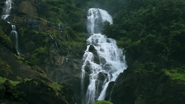 Beautiful waterfall in dark green lush forest,India
