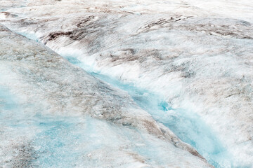 Melting Athabasca glacier with a small river in the ice due to climate change, Jasper national park, Alberta, Canada.