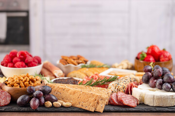 Meat Cheese and Fruit Charcuterie Board on a Marble Kitchen Cabnet