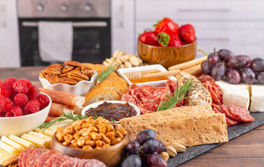 Meat Cheese and Fruit Charcuterie Board on a Marble Kitchen Cabnet