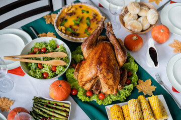 top view of thanksgiving dinner with roasted turkey and fresh vegetables near pumpkin pie and grilled corn