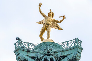 Fragments of July Column (Colonne de Juillet, 1840) with Genie de La Liberty at top on Place de la Bastille. Paris, France.