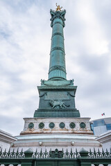 Fototapeta na wymiar Fragments of July Column (Colonne de Juillet, 1840) with Genie de La Liberty at top on Place de la Bastille. Paris, France.