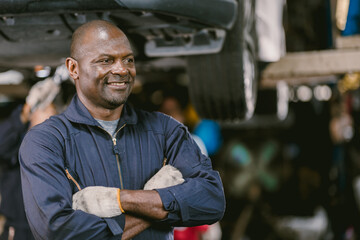 Portrait Black African mechanic garage worker check auto service team staff smart standing happy...