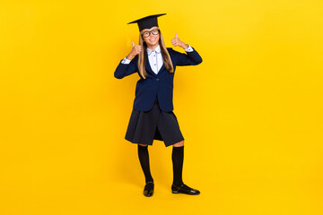Full photo of cheerful optimistic schoolgirl with blond hair wear blue blazer showing thumbs up like isolated on yellow color background
