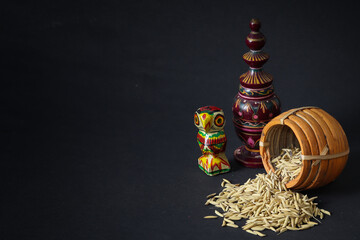 Laxmi puja essentials for rituals kept together. rice paddy grains, wooden owl and other objects symbolizing goddess of riches and prosperity during laxmi puja or makar sankranti in west bengal. - obrazy, fototapety, plakaty