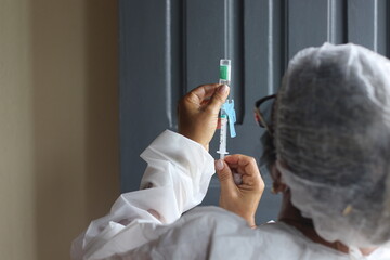 Nurse apply covid-19 vaccine or flu antivirus wear face mask protection against virus disease