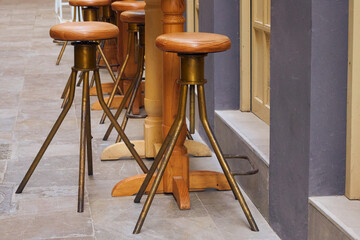 Vintage oxidized copper stool on a bar terrace