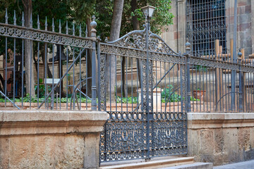 Gate with wrought iron religious ornaments of the Cathedral of Malaga