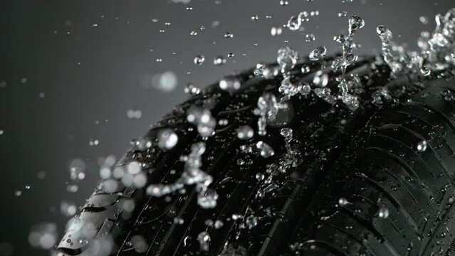 Super slow motion of falling rain on tire sample, close-up. Filmed on high speed cinema camera, 1000 fps.