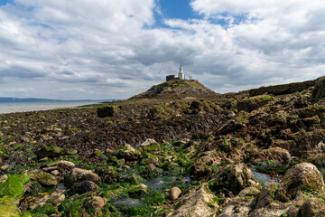 view of the Mumbles Lighthouse in Swansea Bay at low tide