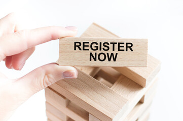 Register Now text on a wooden bar in a girl's hand on a white background