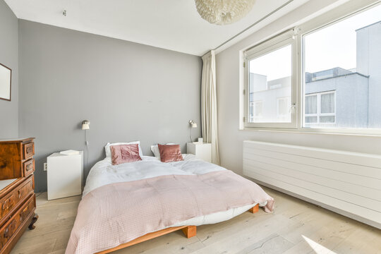Soft bed and nightstand in modern light bedroom