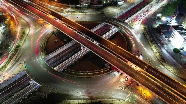 Expressway top view, Road traffic an important infrastructure, car traffic transportation above intersection , aerial view cityscape of advanced innovation, financial technology, 4k Hyperlapse