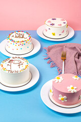 colorful bento cake, blue and pink table, colorful sprinkles and flowers