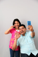 Hispanic Latino dad and daughter play, dance, surprise, enjoy, taking selfies using the cell phone spending quality family time