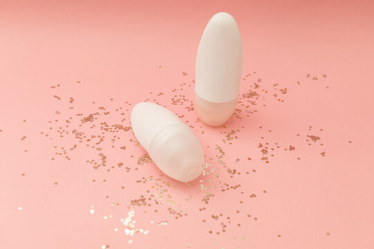 Roller Deodorant In A White Bottle On A Pink Background