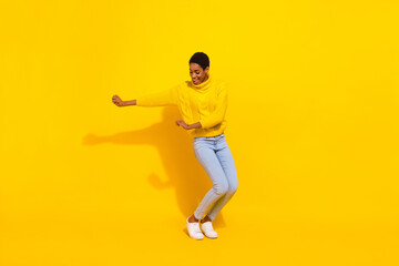 Fototapeta na wymiar Full length body size view of attractive cheerful thin carefree girl dancing moving isolated over vivid yellow color background